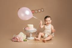 Girl with balloon cake smash for first birthday Girl with balloon cake smash for first birthday