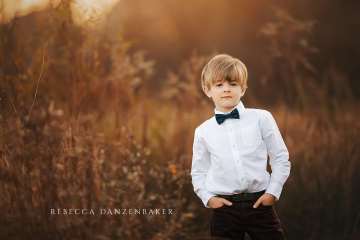 Boy in bowtie in field portrait