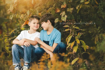 Two brothers sitting on a boulder