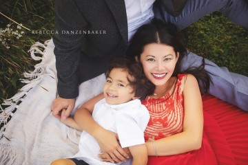 Boy and mom laying on dad's lap during a photo session with Rebecca Danzenbaker in Willowsford Boy and mom laying on dad's lap during a photo session with Rebecca Danzenbaker in Willowsford