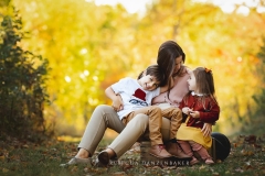 Mother laughing with her two children during a photo session in Northern VA Mother laughing with her two children during a photo session in Northern VA