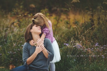 Mother and Daughter snuggle during a family photo session with Rebecca Danzenbaker