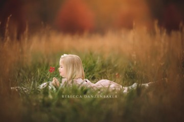 Portrait of girl laying in a field in November during  a family photography session