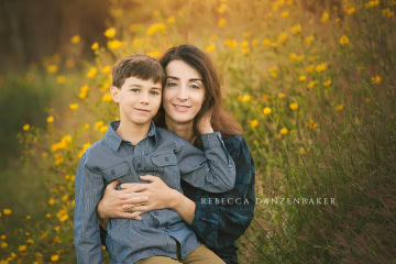 Mother and son among yellow flowers Mother and son among yellow flowers
