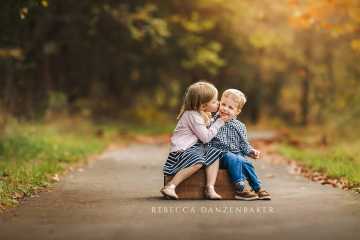 sister kissing her brother's cheek