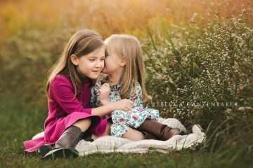 Two sisters sharing a secret Two sisters sharing a secret
