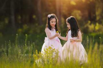 twin sisters in pink dresses