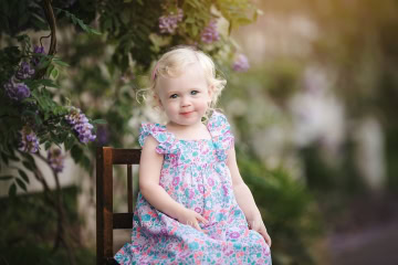 Toddler girl with purple flowers Rebecca Danzenbaker Photography