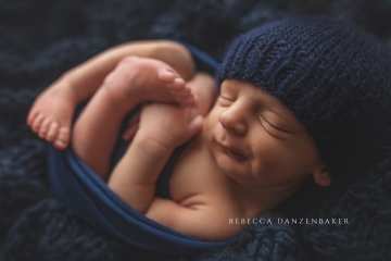 Newborn boy in navy blue props