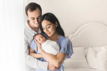 Newborn baby being snuggled by his parents in Northern VA photography studio Newborn baby being snuggled by his parents in Northern VA photography studio