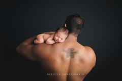 Newborn baby with dad and his Iris back tattoo Newborn baby with dad and his Iris back tattoo