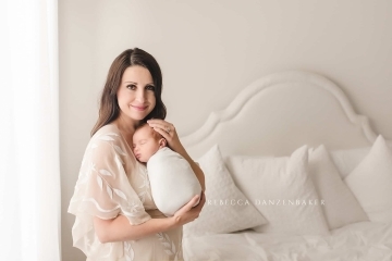 Newborn baby being snuggled by his mother