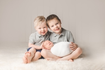 Newborn baby with brothers