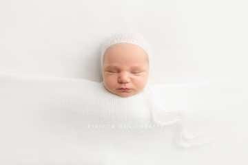 Tucked in sleeping newborn baby photography