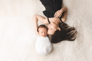 Newborn baby with sister portrait