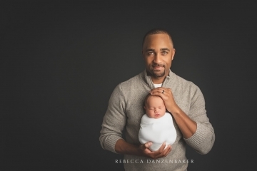 Newborn baby with father portrait
